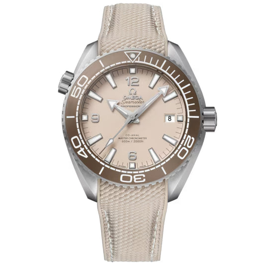 The OMEGA Seamaster Planet Ocean 600M Co-Axial Master Chronometer 43.5mm features a beige dial, brown bezel, matching fabric strap, white hour markers, and a date window at 3 o’clock, shown on a plain white background.