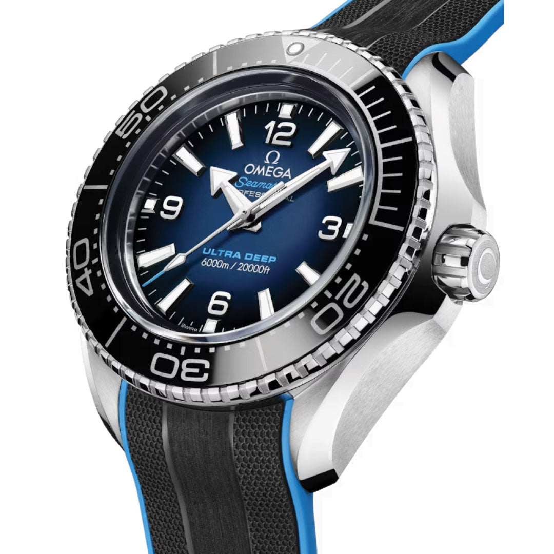 A close-up of the luxurious OMEGA Seamaster Planet Ocean 6000M Ultra Deep Co-Axial Master Chronometer 45.5mm watch showcases its blue dial, white markers, and black bezel. This water-resistant timepiece features prominent hour numbers and is complemented by a black and blue strap, emphasizing its remarkable 6000m capability consistent with the iconic OMEGA Seahorse design.