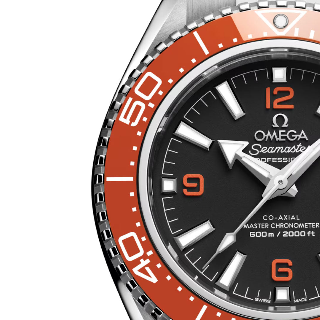 Close-up of the OMEGA Seamaster Planet Ocean 600M Co-Axial Master Chronometer 42mm Watch, featuring a black dial, white and orange hour markers, silver hands, red accents, an orange bezel, and water resistance to 600 m/2000 ft.