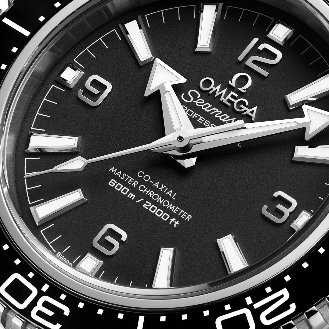 Close-up of the OMEGA Seamaster Planet Ocean 600M Co-Axial Master Chronometer 42mm watch face, featuring bold white hour markers, broad hands, and "600m/2000ft" on the black dial—hallmarks of this premium OMEGA dive watch.