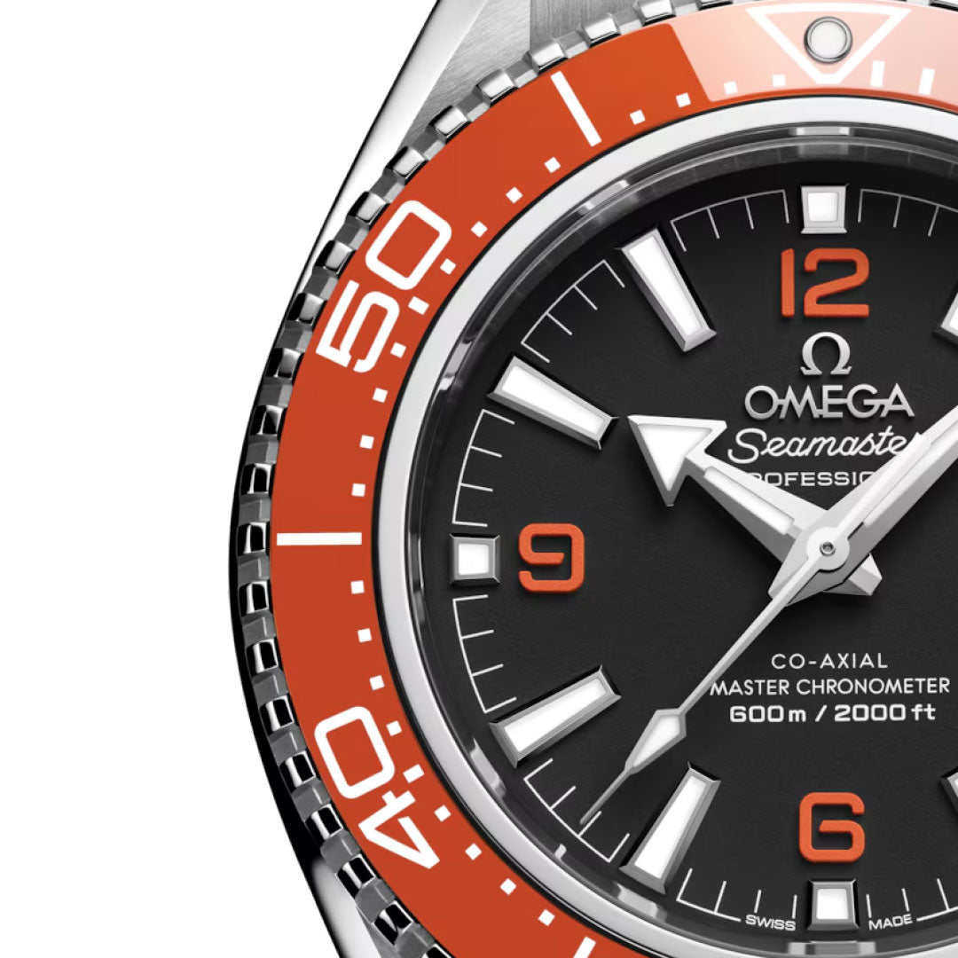 Close-up of the OMEGA Seamaster Planet Ocean 600M Co-Axial Master Chronometer 42mm Watch, featuring an orange bezel, black dial with white hour markers and hands, and prominent OMEGA branding with certification details.