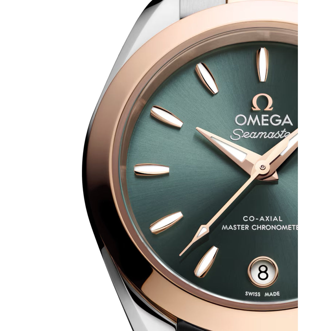 Close-up of the OMEGA Seamaster Aqua Terra 150M Co-Axial Master Chronometer 30mm watch, featuring a green dial, gold hands and markers, date at 6 o’clock, and a rose gold and silver bezel.