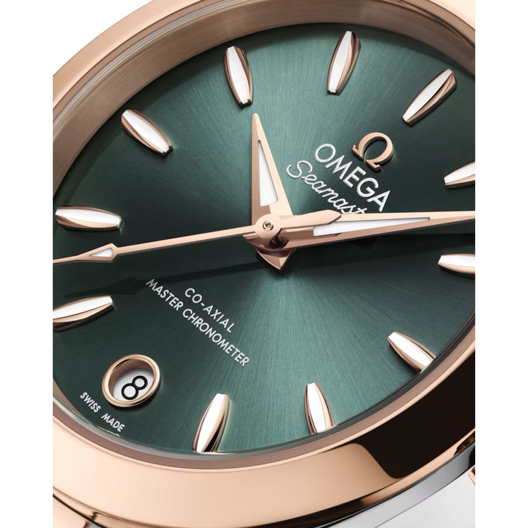 Close-up of the OMEGA Seamaster Aqua Terra 150M Co-Axial Master Chronometer 30mm Watch, featuring a green sunburst dial, rose gold markers and hands, a date window at 6 o’clock, and OMEGA branding.