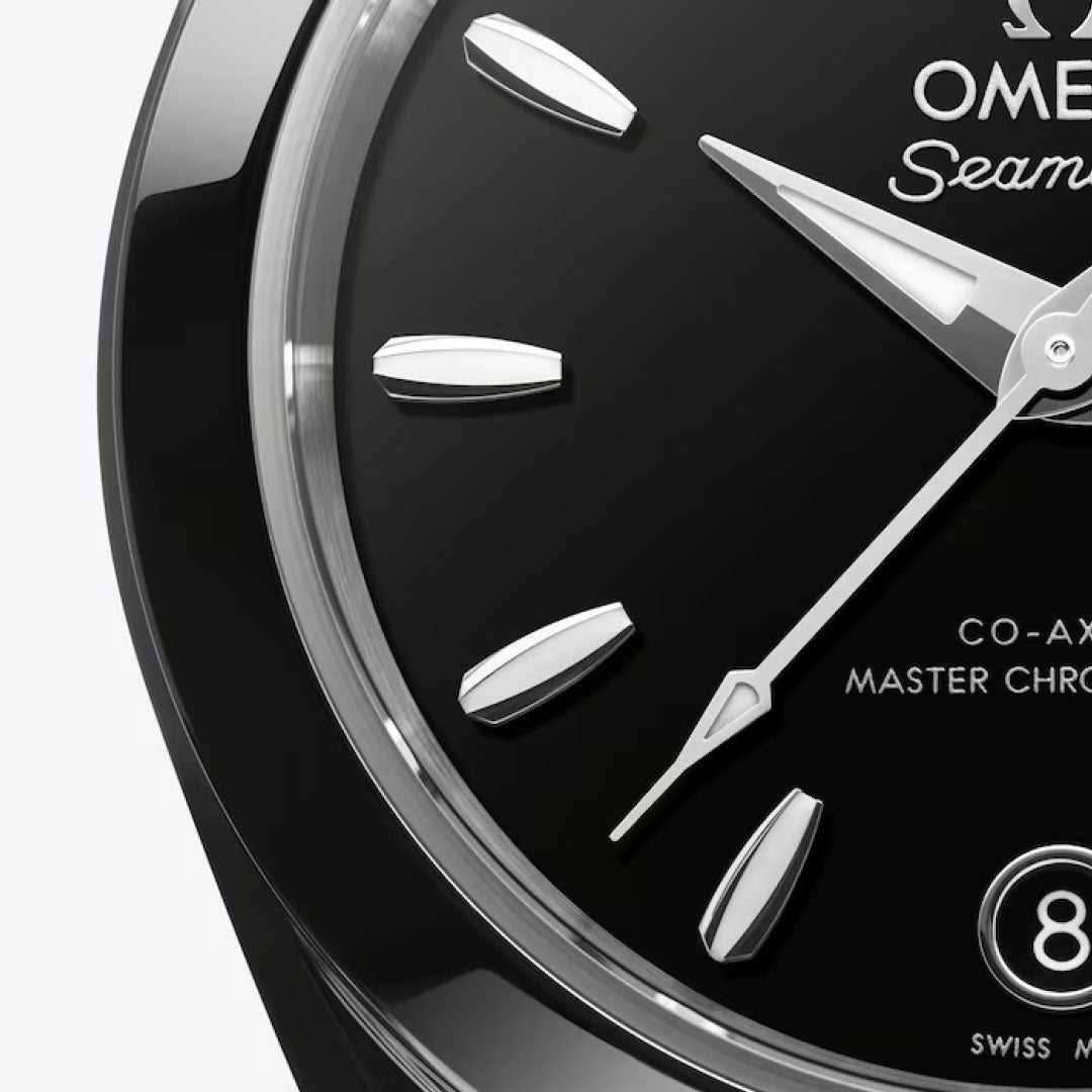 Close-up of the OMEGA Seamaster Aqua Terra 150M Co-Axial Master Chronometer 30mm watch, featuring a glossy black dial with silver hour markers, two hands at different positions, date at 8, and partial OMEGA branding.