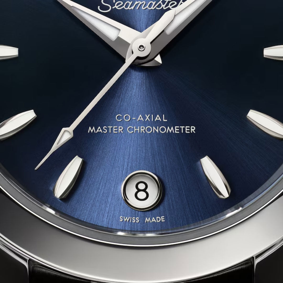 Close-up of the OMEGA Seamaster Aqua Terra 150M Co-Axial Master Chronometer 30mm Watch with a deep blue dial, silver markers and hands, date window at 6 o’clock, and "Seamaster" and "Swiss Made" on the stainless steel face.