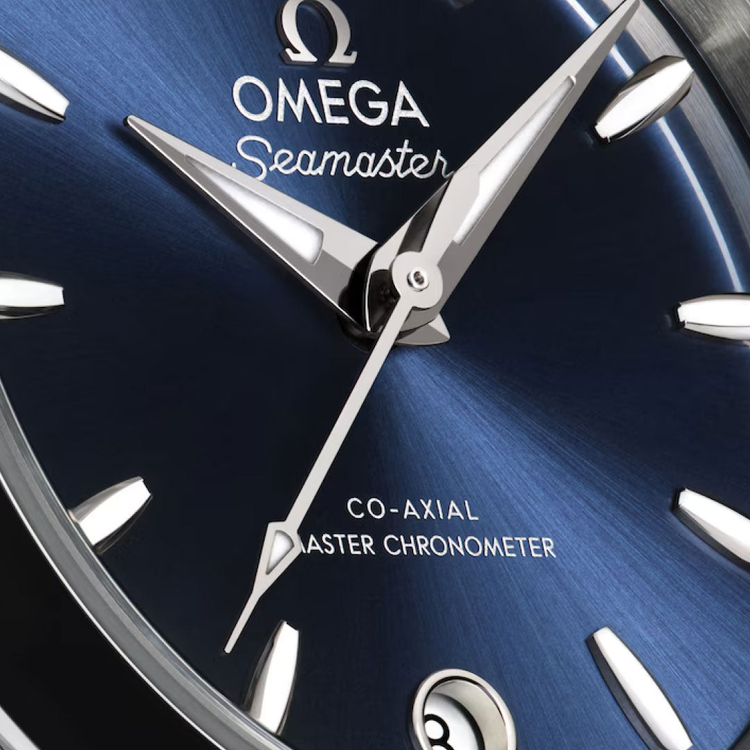 Close-up of the OMEGA Seamaster Aqua Terra 150M Co-Axial Master Chronometer 30mm watch, featuring a blue sunburst dial, silver markers and hands, and "OMEGA Co-Axial Master Chronometer" above the date at 6 o'clock.