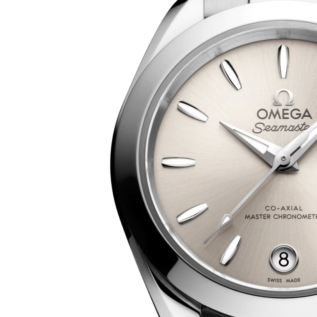 Close-up of the OMEGA Seamaster Aqua Terra 150M Co-Axial Master Chronometer 30mm watch, featuring a silver dial, polished bezel, minimal hour markers, and a date window at 6 o'clock. Only part of the OMEGA watch face is visible.