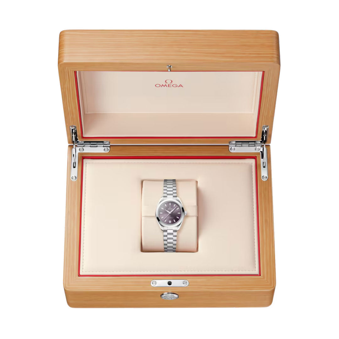 The OMEGA Seamaster Aqua Terra 150M Co-Axial Master Chronometer 30mm watch with a silver metal band is displayed in a light wood and cream box, featuring the OMEGA logo on the inner lid.