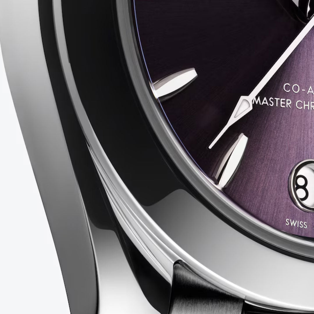 Close-up of the OMEGA Seamaster Aqua Terra 150M Co-Axial Master Chronometer 30mm watch with a dark purple dial, silver hour markers, white hands, date window at 6 o’clock, and a polished metal case from OMEGA.