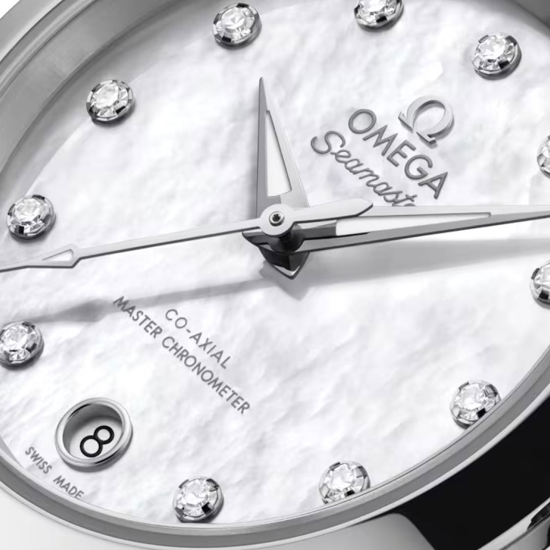 Close-up of the OMEGA Seamaster Aqua Terra 150M Co-Axial Master Chronometer 30mm watch, featuring a white textured dial, diamond hour markers, date at 6 o’clock, silver hands, and “Co-Axial Master Chronometer” on the dial.
