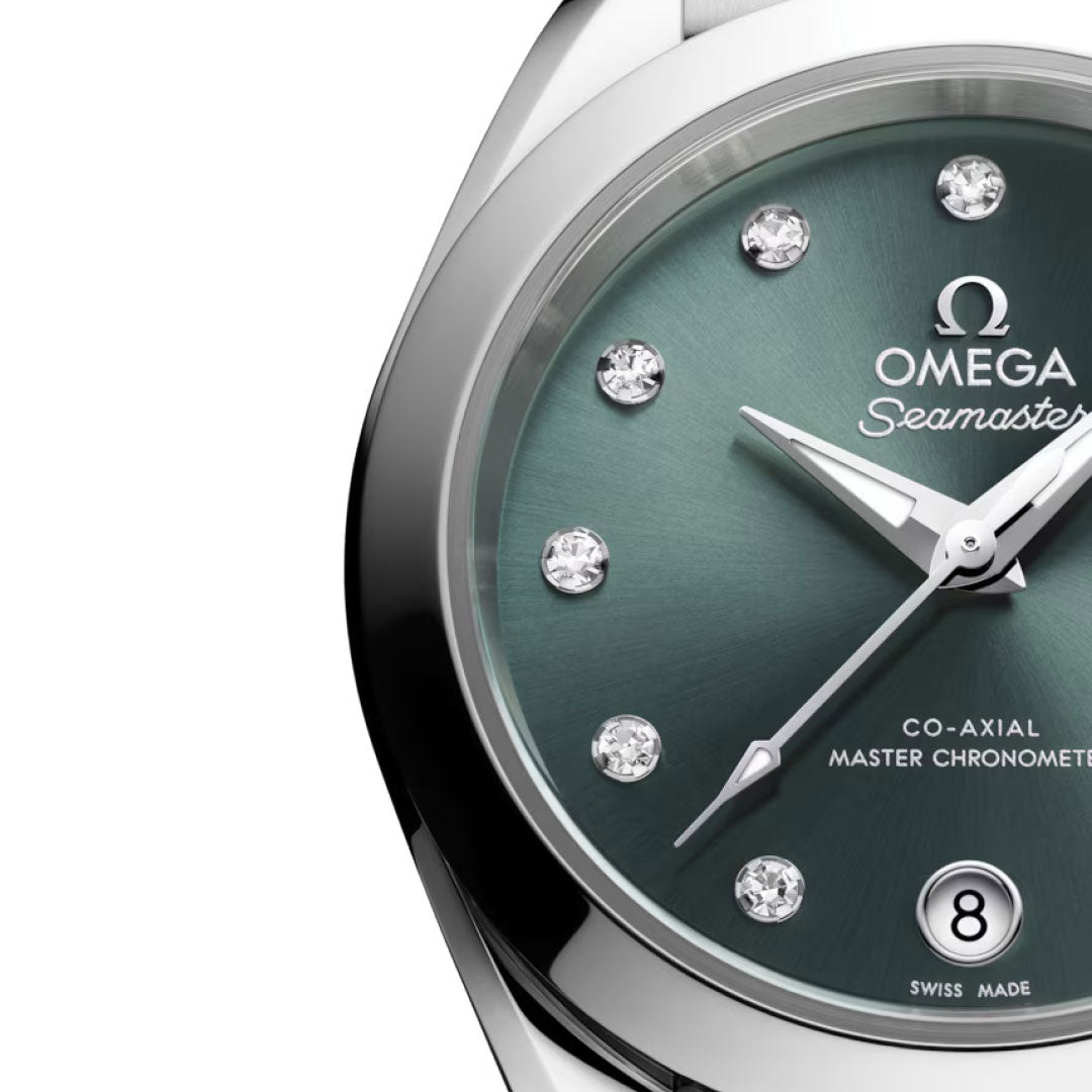Close-up of the OMEGA Seamaster Aqua Terra 150M Co-Axial Master Chronometer 30mm Watch featuring a green sunburst dial, diamond hour markers, silver hands, date window at 6 o’clock, and "Seamaster" script below the logo.