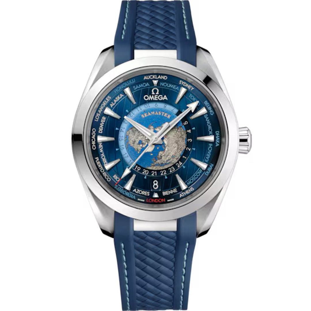 The OMEGA Seamaster Aqua Terra 150M Worldtimer features a blue and silver dial with city names, a blue textured strap, stainless steel bezel, and is powered by the Master Chronometer Calibre 8938. It includes intricate detailing like silver hour markers and hands.