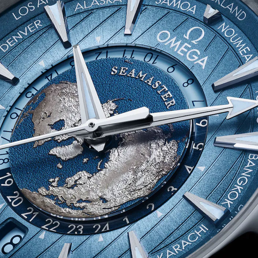 Close-up of the OMEGA Seamaster Aqua Terra 150M Worldtimer Co-Axial Master Chronometer 43mm Summer Blue Edition, showcasing its textured world map dial, city ring, and silver hands—a blend of precision and distinctive style.