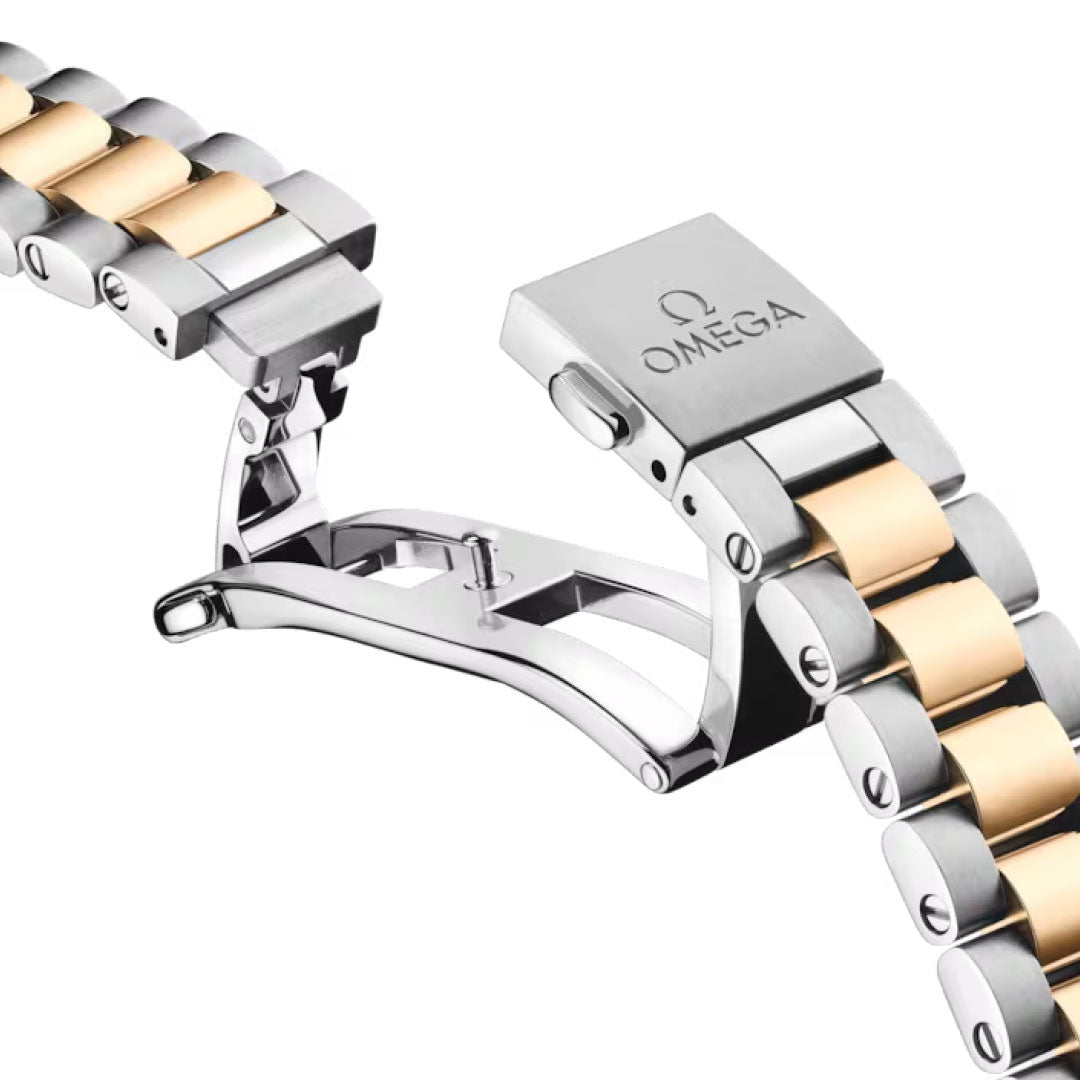 Close-up of the OMEGA Seamaster Aqua Terra 150M Co-Axial Master Chronometer 30mm watch bracelet in silver and gold tones, showcasing an Omega-engraved deployment clasp—an elegant signature from this OMEGA collection.