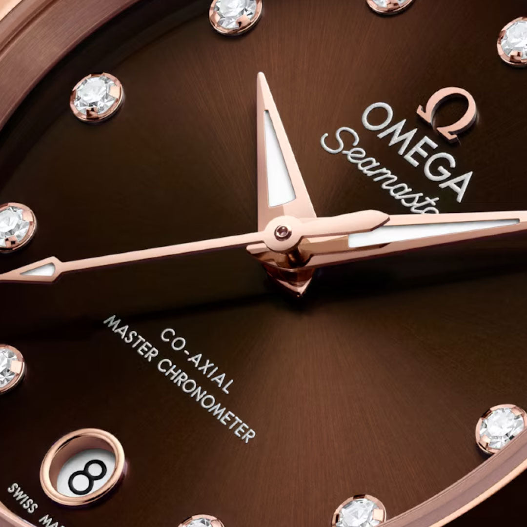Close-up of the OMEGA Seamaster Aqua Terra 150M Co-Axial Master Chronometer 30mm watch face, featuring diamond hour markers, 18K Sedna Gold hands, a 6 o’clock date window, and “Co-Axial Master Chronometer” on the dial.