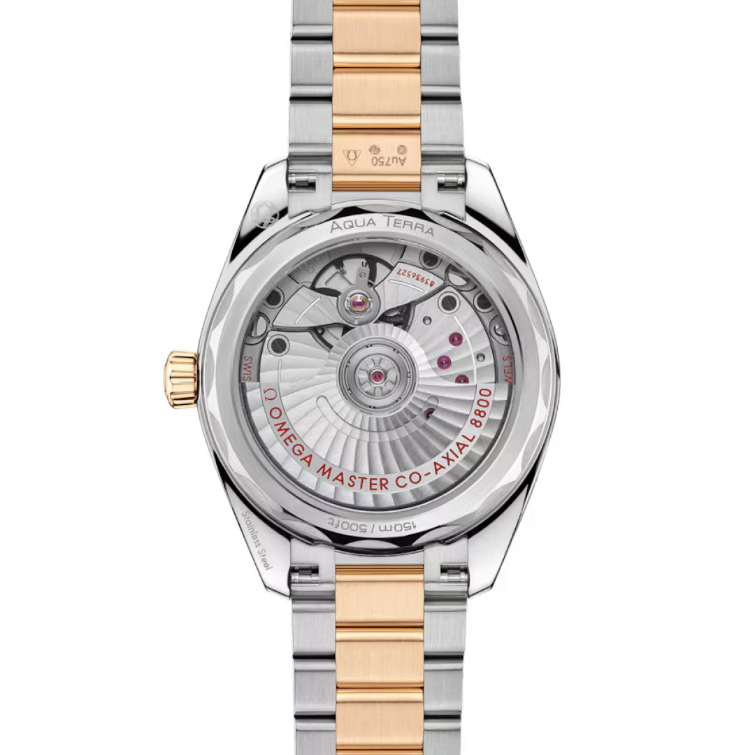 A close-up of the OMEGA Seamaster Aqua Terra Shades Co-Axial Master Chronometer 34mm Watch showcases its calibre 8800 through a transparent caseback and a two-tone silver and Moonshine™ Gold bracelet, with “Omega Master Co-Axial 8800” in red.