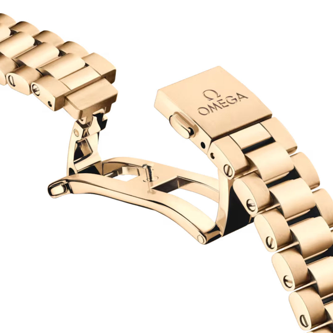 A close-up of the OMEGA Seamaster Aqua Terra 150M Co-Axial Master Chronometer 41mm watch bracelet in 18K Moonshine gold shows its open deployment clasp with the engraved OMEGA logo, set against a white background.