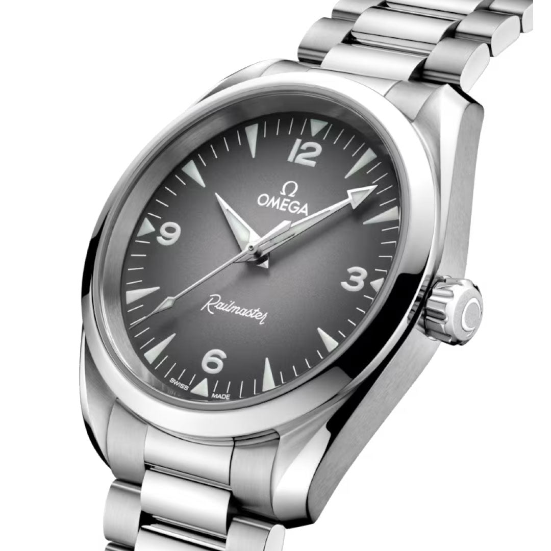 A close-up of the OMEGA Seamaster Railmaster Co-Axial Master Chronometer 38mm Watch features a stainless steel band, black gradient dial, silver hour markers, white hands at 10:09, and visible OMEGA branding with "Railmaster" on the dial.