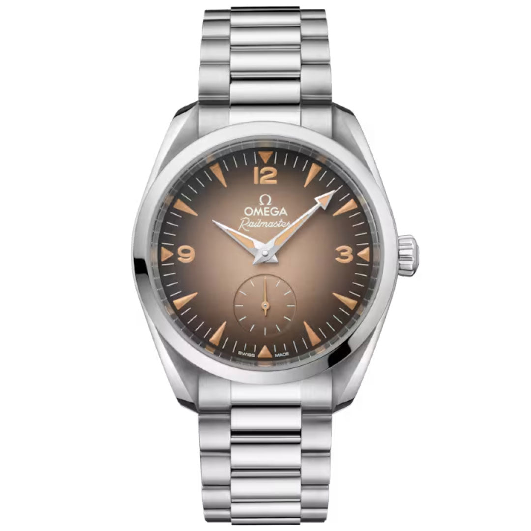 The OMEGA Seamaster Railmaster Co-Axial Master Chronometer 38mm Watch features a stainless steel case, gradient brown dial with luminous hands, Arabic numerals at 3, 6, 9, and 12, and a steel link bracelet.