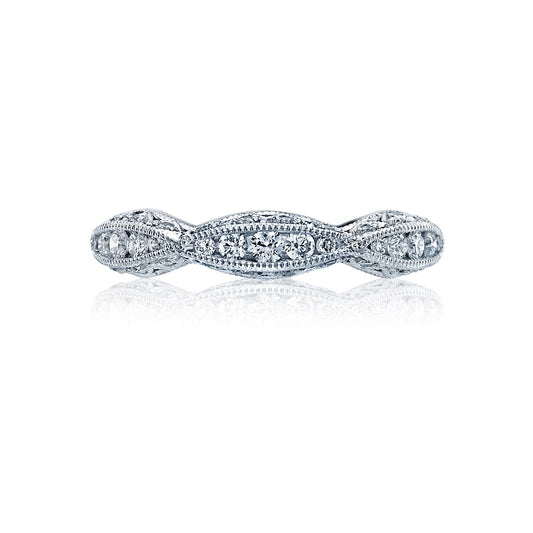 The Tacori Classic Crescent Twist 18K White Gold Round Brilliant Diamond Accent Anniversary Ring showcases a twisted design, enhanced by diamond accents and intricate detailing along the band. Expertly crafted by Tacori gemologists, it embodies elegance in every curve and makes a stunning choice for an engagement ring.