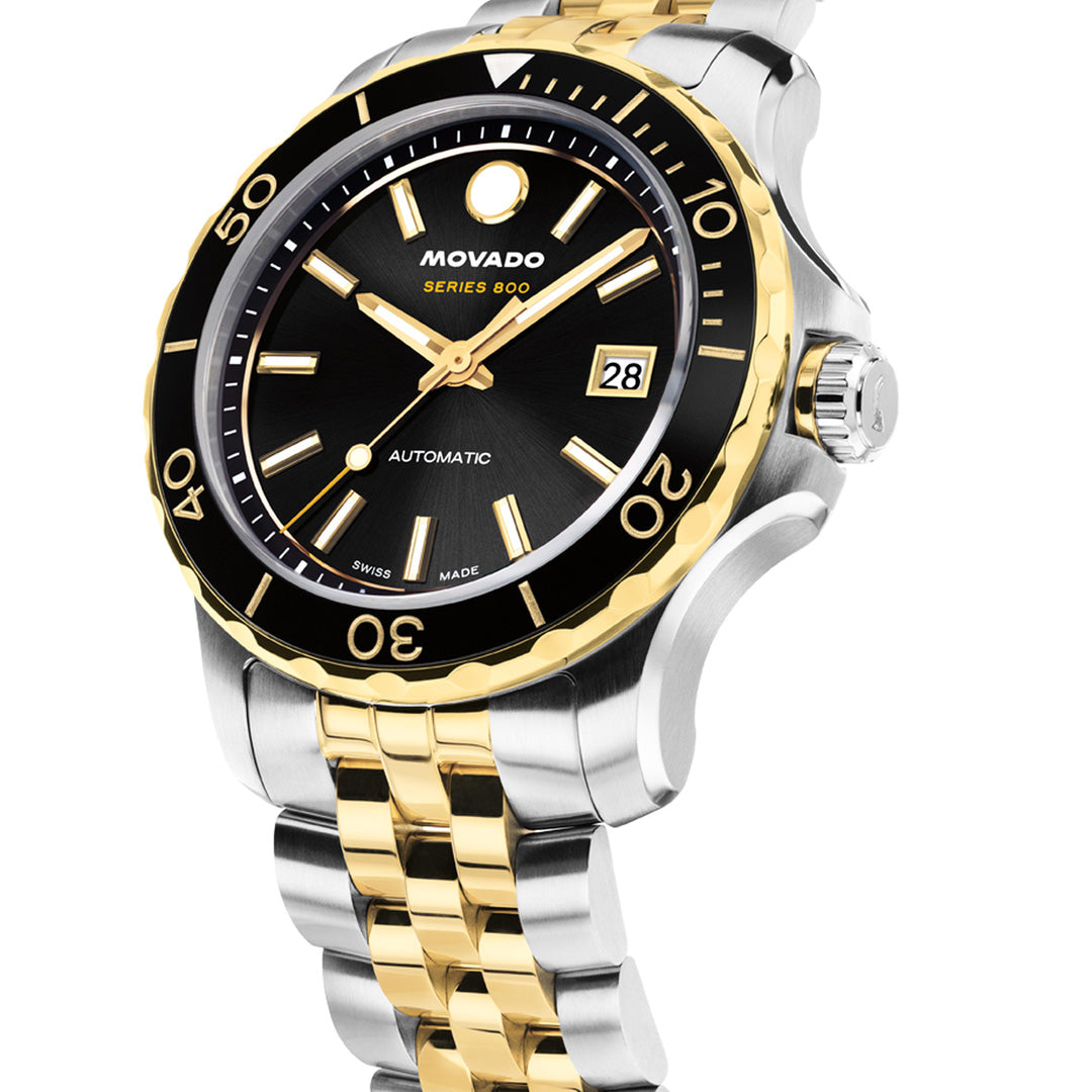 The Movado Series 800 Automatic 40mm Watch by Movado features a two-tone stainless steel case, black and gold bezel, black dial with date display, and a silver and gold metal link bracelet. This Swiss-made automatic timepiece is angled to the right, highlighting its intricate design details.