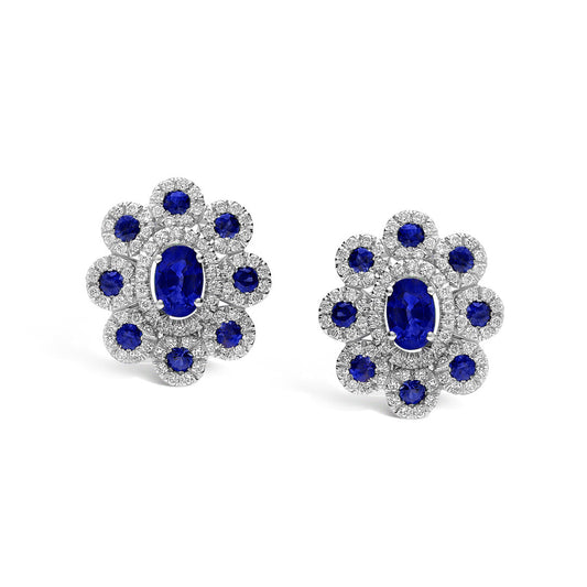 Experience vintage elegance with Leo Pizzo Augusta Collection 18K White Gold Diamond Sapphire Stud Earrings, featuring a large central blue gemstone surrounded by natural sapphires and sparkling gems.