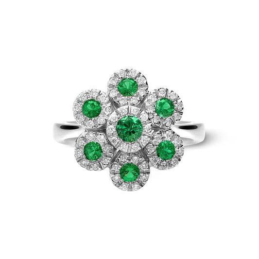 The Leo Pizzo Augusta Collection 18K White Gold Diamond Emerald Fashion Ring features a floral motif with a central green gemstone surrounded by six smaller emeralds, each encircled by diamonds, complemented by a sleek band for added elegance.