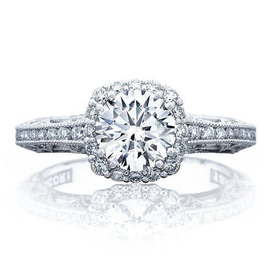 The Tacori Reverse Crescent 18K White Gold Round Brilliant Semi Mount Engagement Ring is a dazzling piece from Tacori, featuring a large central round diamond surrounded by a halo of pavé-set diamonds. The elegantly adorned band, set with additional diamonds, amplifies its elegance and brilliance—truly capturing the timeless allure of exquisite engagement rings.
