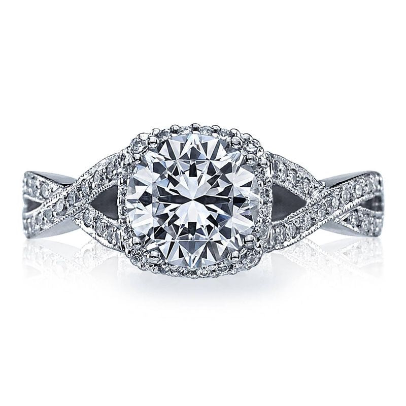 Introducing the Tacori Dantela 18K White Gold Round Brilliant Semi Mount Engagement Ring, a stunning piece by Tacori. This exquisite ring features a large round center setting designed to accommodate your choice of diamond, surrounded by a hidden halo and adorned with smaller diamonds along the twisted band. This meticulous design enhances the ring's sparkle and intricate detail, making it an ideal choice for an engagement ring.