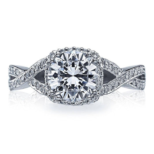 Introducing the Tacori Dantela 18K White Gold Round Brilliant Semi Mount Engagement Ring, a stunning piece by Tacori. This exquisite ring features a large round center setting designed to accommodate your choice of diamond, surrounded by a hidden halo and adorned with smaller diamonds along the twisted band. This meticulous design enhances the ring's sparkle and intricate detail, making it an ideal choice for an engagement ring.