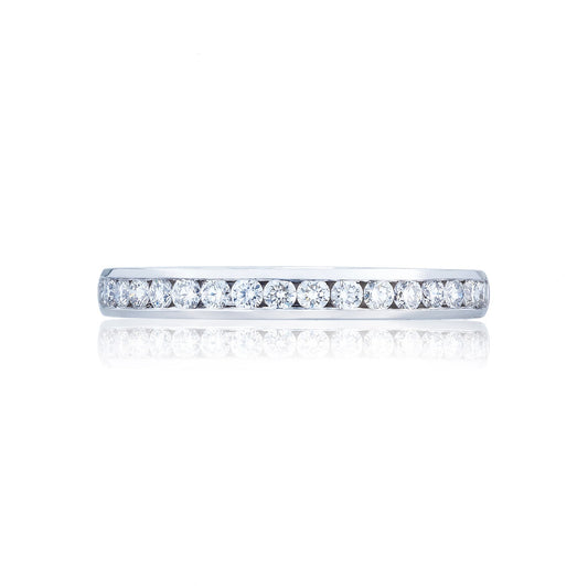 A horizontal image showcases the exquisite Tacori Dantela 18K White Gold Channel Set Round Brilliant Anniversary Ring, featuring a row of small, round diamonds that shimmer on a lustrous white gold band. Its elegance and craftsmanship are emphasized against a white background, making it an ideal choice for those in search of stunning engagement rings.