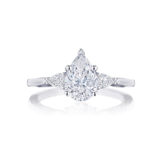 This stunning Tacori Simply 18K White Gold Pear Semi Mount Engagement Ring showcases a pear-shaped diamond with an 18K white gold band, adorned with two smaller side stones and diamond accents, all elegantly presented on a Cathedral foundation.