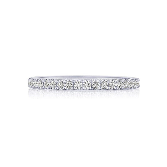 The Tacori Simply 18K White Gold Round Brilliant French Pavé Diamond Eternity Ring, showcasing a row of G color VS clarity diamonds set closely on a white gold band, is elegantly displayed against a white background, embodying the Signature Crescent style.