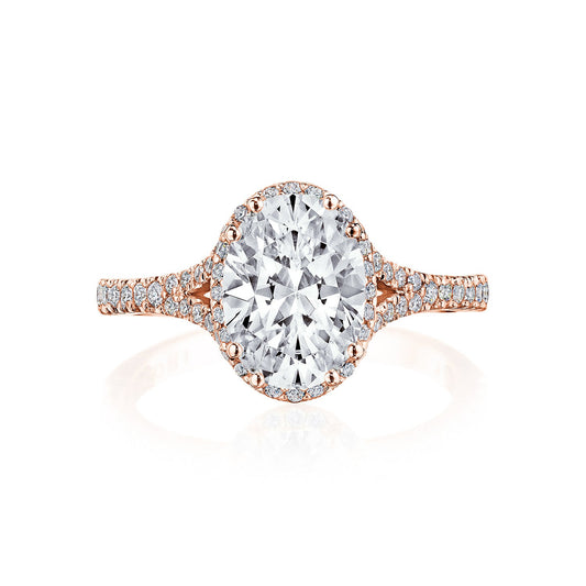 The Tacori Dantela 18K Rose Gold Oval Semi Mount Engagement Ring boasts an exquisite design with a striking central diamond encircled by a halo of smaller G color diamonds. Its lace-like Cathedral band, also adorned with sparkling diamonds, epitomizes the elegant brilliance characteristic of Tacori's engagement rings.