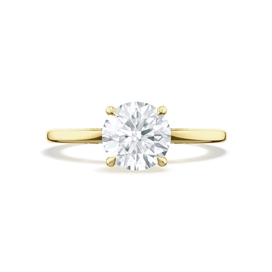 The Tacori Simply 18K Yellow Gold Round Brilliant Solitaire Semi Mount Engagement Ring with Diamond Accent Band is showcased on a plain white background, highlighting the elegance of a bridal gown through its Signature Crescent design.
