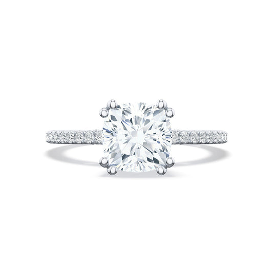 Featuring the Tacori Simply 18K White Gold Cushion Semi Mount with Diamond Band and Hidden Halo Engagement Ring, this exquisite Tacori piece highlights bridal details on a slender band adorned with pavé diamonds, accentuating the brilliance of the central gem with its cushion-cut design and six-prong setting.