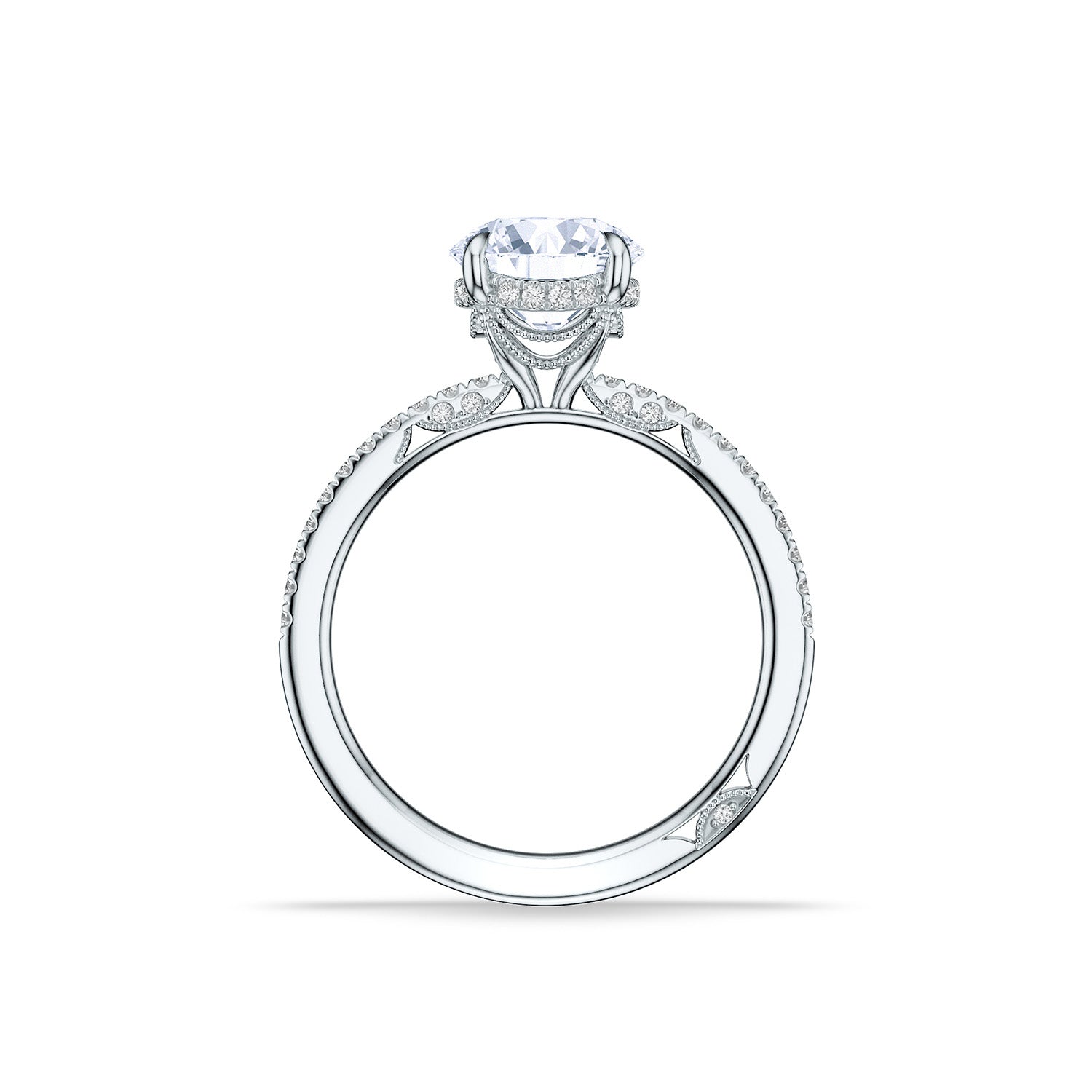 The Tacori Simply 18K White Gold Round Brilliant Semi Mount Engagement Ring features a large round diamond atop its band, adorned with intricate bridal details and pavé diamonds for an elegant and luxurious look. Displayed upright against a white background, this stunning piece also includes a hidden halo for added brilliance.