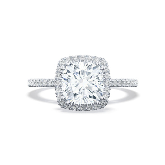 The Tacori Simply Tacori 18K Yellow Gold Cushion Semi Mount with Diamond Band and Halo Engagement Ring features a stunning center cushion-cut diamond surrounded by a sparkling halo of smaller diamonds. Its band, designed with the elegance reminiscent of a Cathedral foundation, is encrusted with additional diamonds to enhance its overall brilliance.