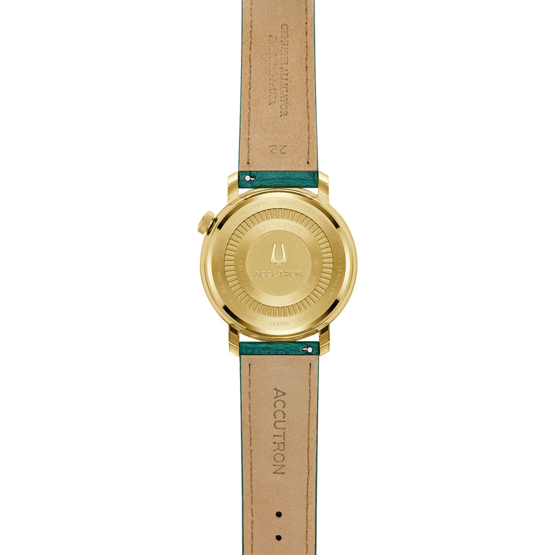 The image shows the back of the Accutron Spaceview Evolution x La Palina Goldie Electrostatic 43.5mm Watch with a brown leather strap, green accents, engraved branding, and "ACCUTRON" stamped on the strap with visible stitching.