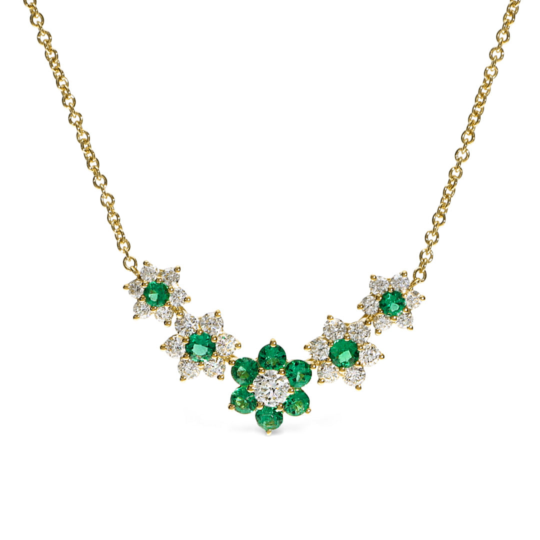 The Leo Pizzo Flora Collection necklace pendant showcases five floral clusters of natural emeralds and diamonds in a symmetrical design, crafted in 18K white gold.