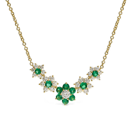 The Leo Pizzo Flora Collection necklace pendant showcases five floral clusters of natural emeralds and diamonds in a symmetrical design, crafted in 18K white gold.