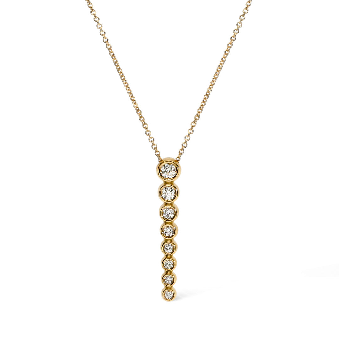 The Leo Pizzo Bubble Collection necklace by Leo Pizzo is an 18K yellow gold piece featuring a vertical pendant with eight natural diamonds in gold bezels, decreasing in size along a delicate chain.