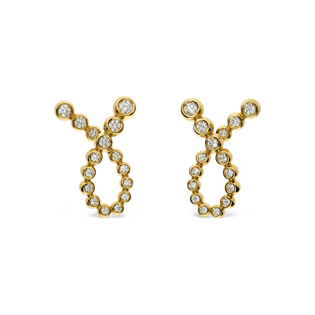 These Leo Pizzo Bubble Collection earrings are crafted in 18K yellow gold and beautifully shaped like the Taurus zodiac symbol. Embellished with natural diamonds, they sparkle as stones elegantly trace the symbol's curves and horns.