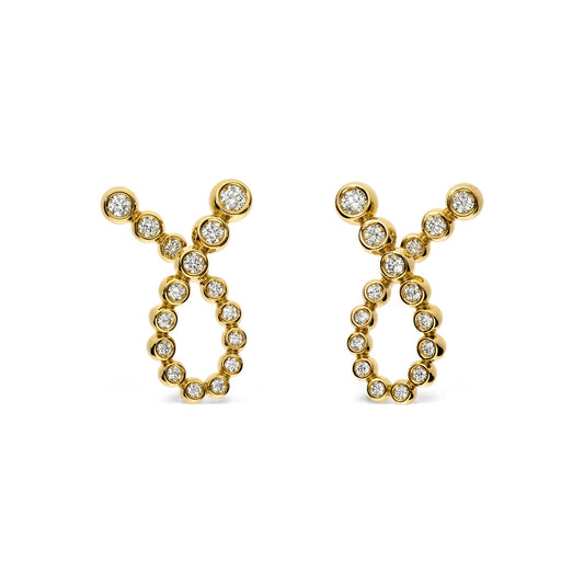 These Leo Pizzo Bubble Collection earrings are crafted in 18K yellow gold and beautifully shaped like the Taurus zodiac symbol. Embellished with natural diamonds, they sparkle as stones elegantly trace the symbol's curves and horns.