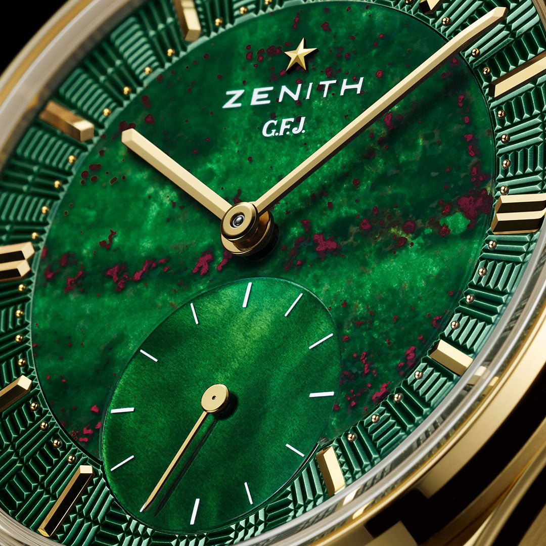 Close-up of the Zenith G.F.J. Calibre 135 Automatic 39.15mm, featuring a vibrant green and gold dial with gold hands, small seconds subdial, elegant gold indices, subtle red speckles, and the Zenith logo on this limited edition watch.