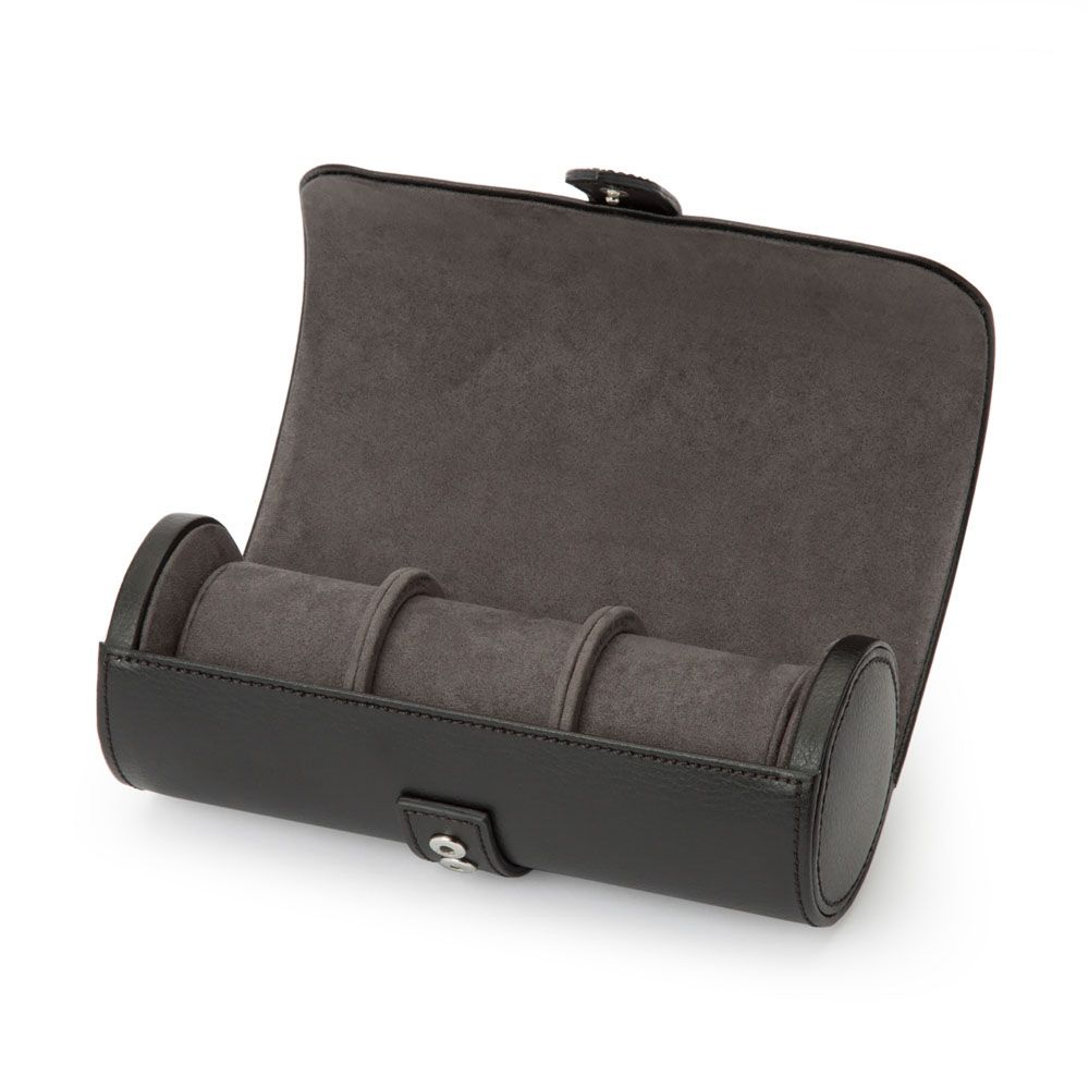 The WOLF 1834 Blake With Capsule Watch Roll in Black/Grey features expertly handcrafted black leather and a sophisticated gray suede interior. When open, it reveals three compartments for watches, each secured with a snap button for added protection. Designed by WOLF, this elegant watch roll perfectly combines style and security, making it an ideal travel companion for your cherished timepieces.