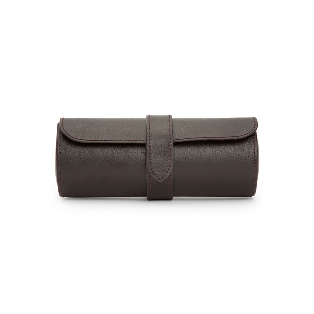 Dark brown, cylindrical leather watch roll with a flap and a central strap closure, displayed on a white background. The WOLF 1834 Blake Triple Watch Roll Brown by WOLF is beautifully handcrafted—perfect for storing your timepieces in style.