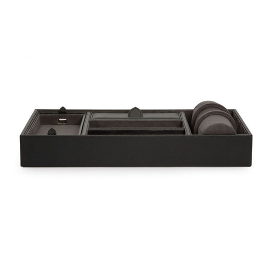The WOLF 1834 Blake Valet Jewellery and Watch Tray With Cuff by WOLF is a rectangular black leather organizer with compartments for keys, small accessories, and a dedicated watch cuff, shown from the front.