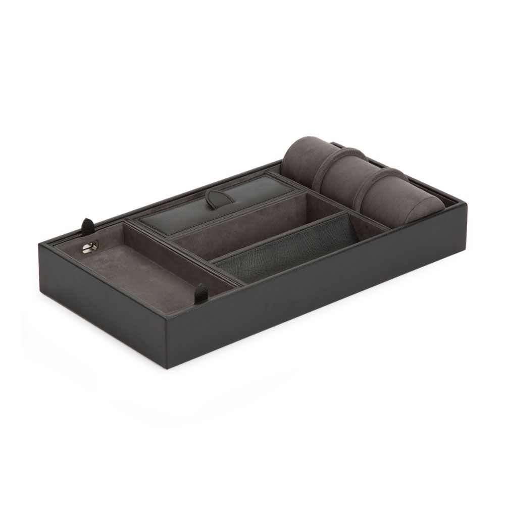 The WOLF 1834 Blake Valet Jewellery and Watch Tray With Cuff by WOLF features black leather, multiple compartments including a watch roll, a small covered section, open accessory slots, and is lined with soft grey fabric.