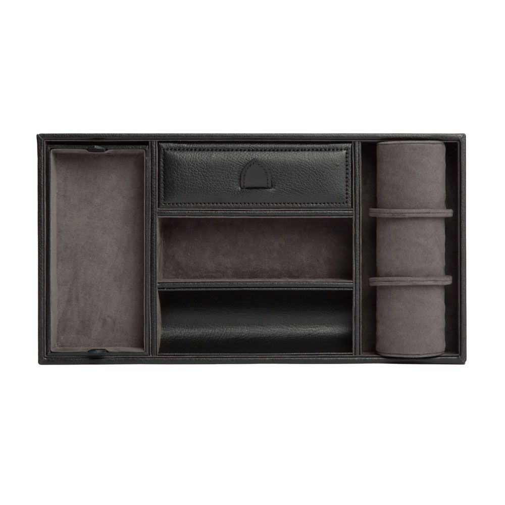 The WOLF 1834 Blake Valet Jewellery and Watch Tray With Cuff by WOLF is a rectangular black leather organizer featuring a watch cuff, a covered compartment, and multiple open sections for storing accessories.